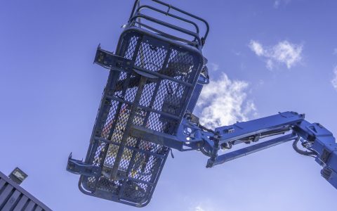 Cherry Picker Crane Underneath blue clear skies - From below